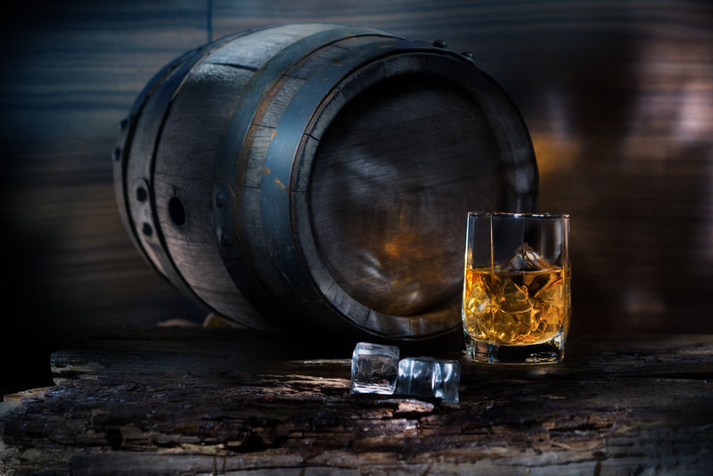 一杯背景桶上有冰块的威士忌