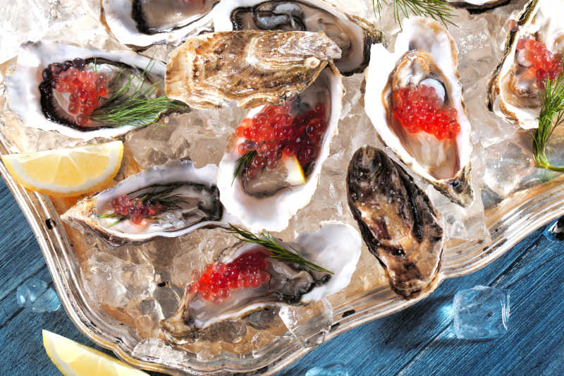 盘子里冰块上的新鲜牡蛎和鱼子酱