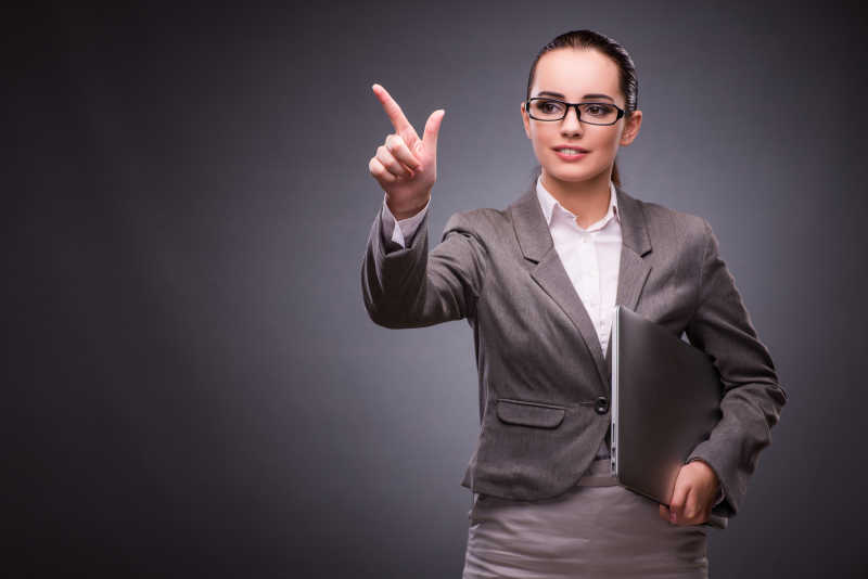 抱着笔记本电脑的年轻女商人