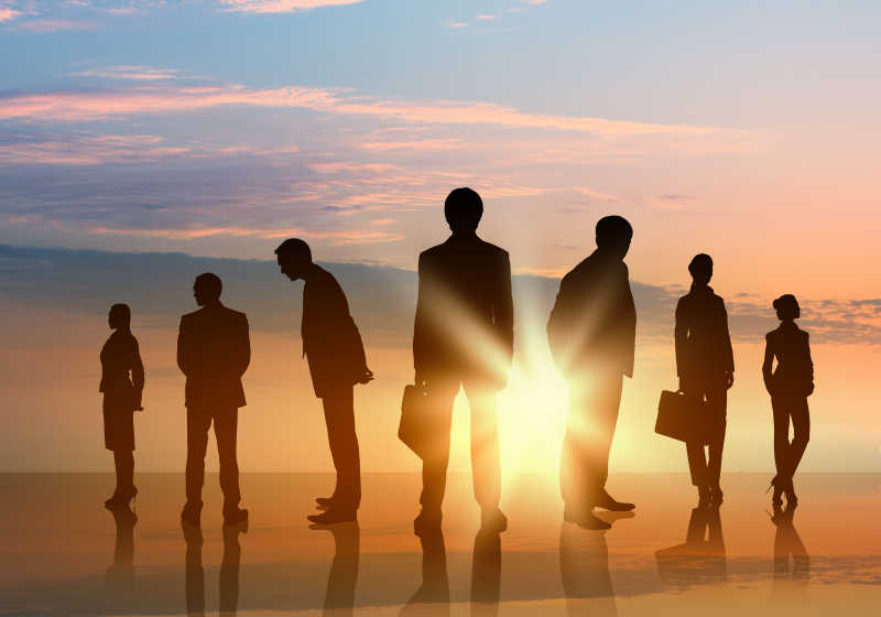 阳光下站立拎着公文包的业务团队