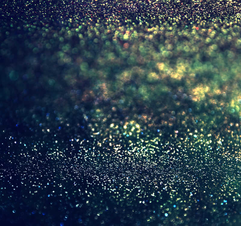 黑色背景上的绿色光晕和闪烁的灯光