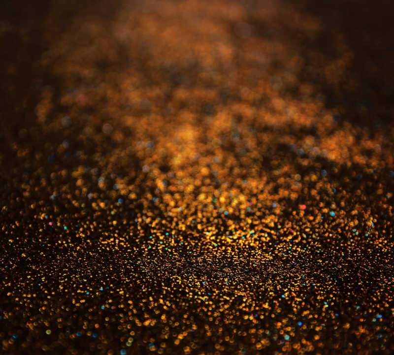 黑色背景上的金色闪烁灯光