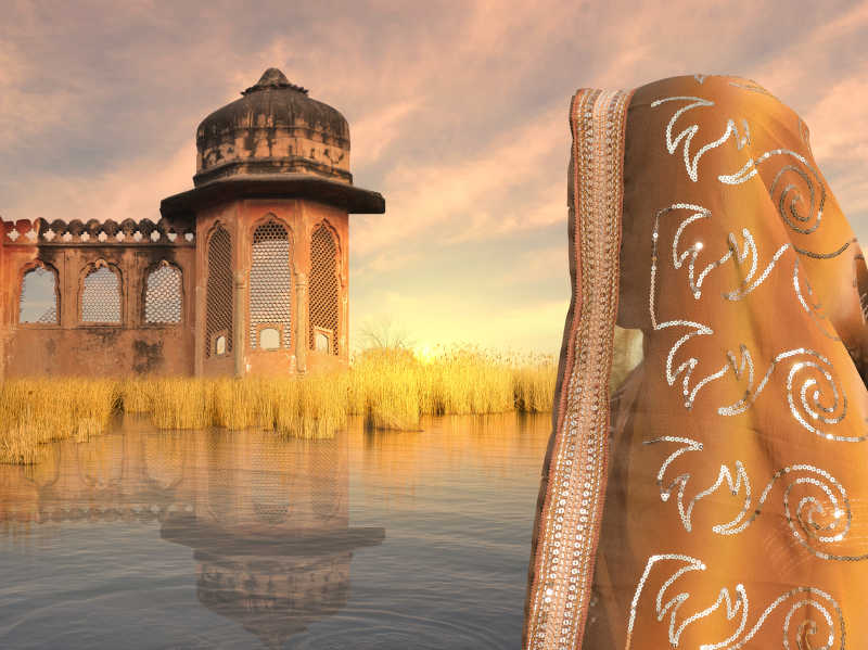 印度建筑和夕阳下的印度女性