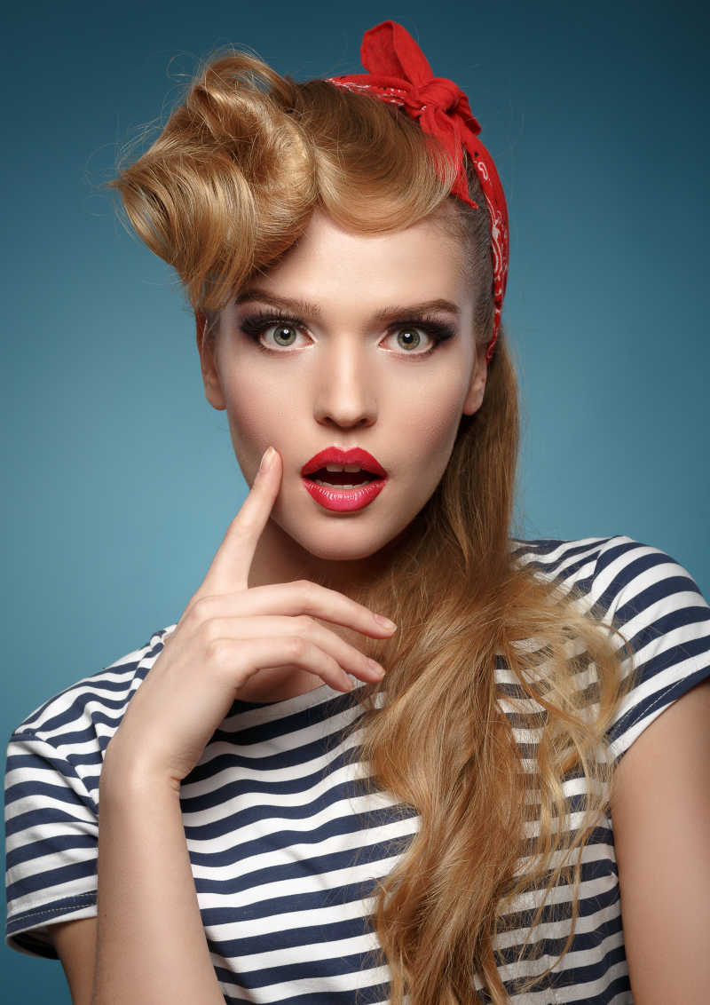 在蓝色背景上的金发红唇美女