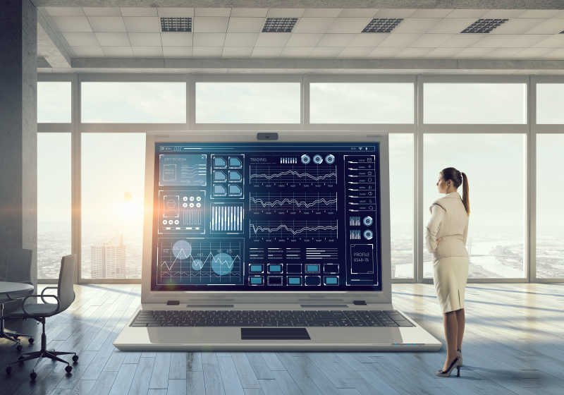 现代室内大笔记本电脑的图形和图表的年轻商人