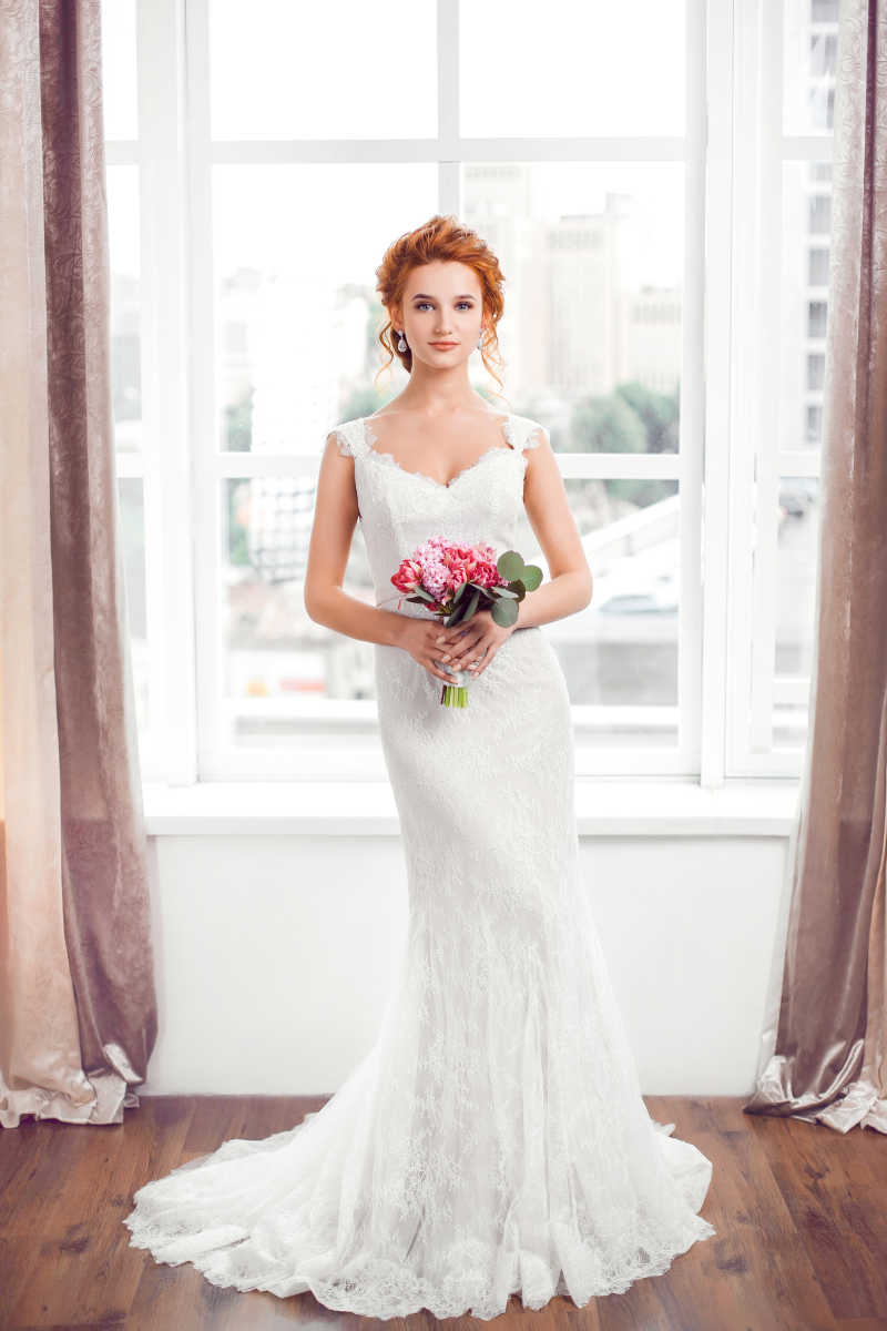 穿着婚纱手里拿着花的美女