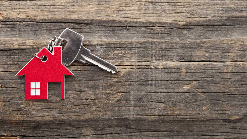 在老式木制背景上带有钥匙扣的钥匙