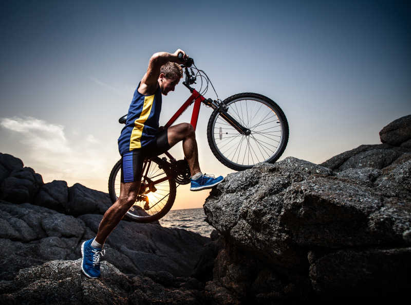 日落时分穿越岩石地带的骑车人