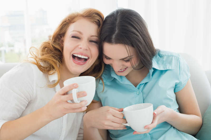 喝着咖啡杯聊天的两个女性朋友