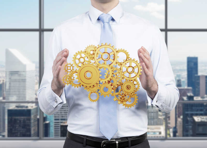 男子手中的金色齿轮