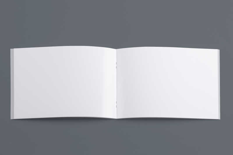 灰色背景下的打开的白色日记本