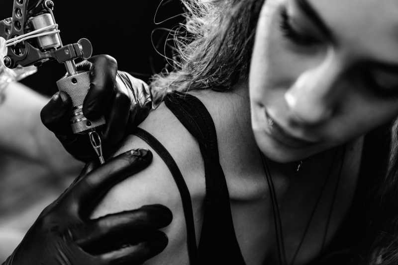 纹身师在帮美女纹身