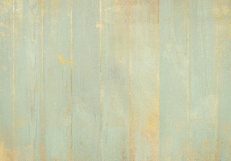 浅绿色粉彩黄金飞溅的木质背景