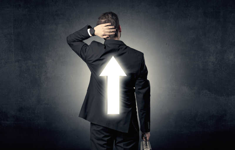 年轻商人站着思考选择哪一个方向