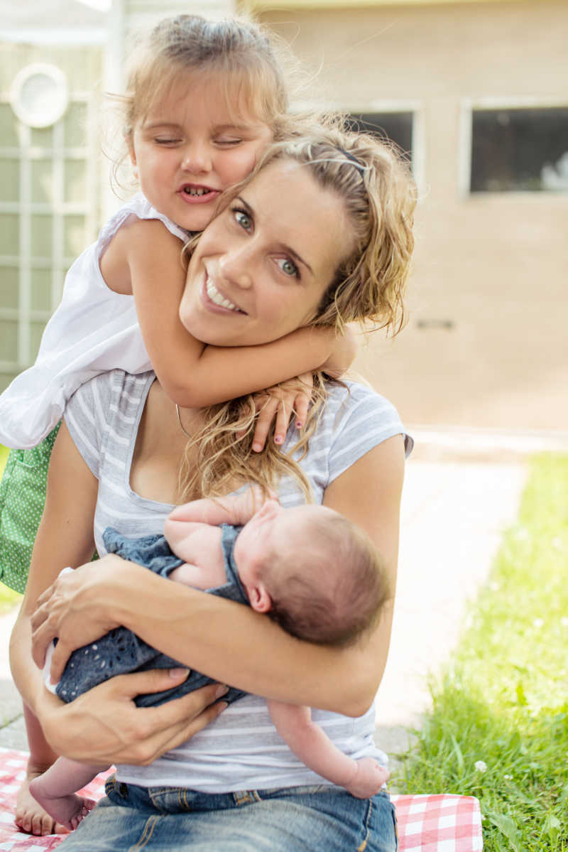 母亲和两个女儿在外面拥抱