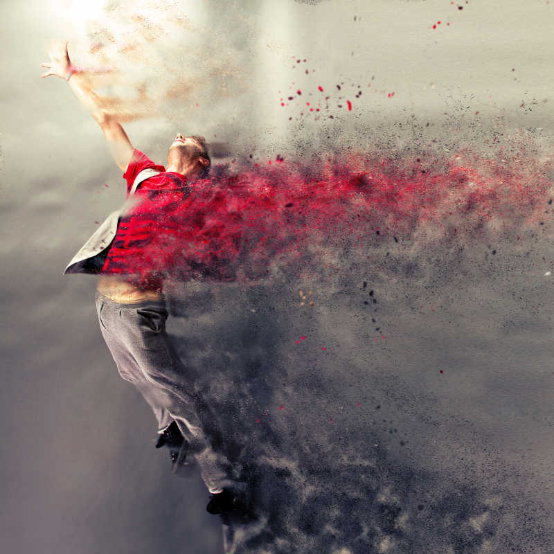 灰色背景下超现实主义舞蹈的男舞者