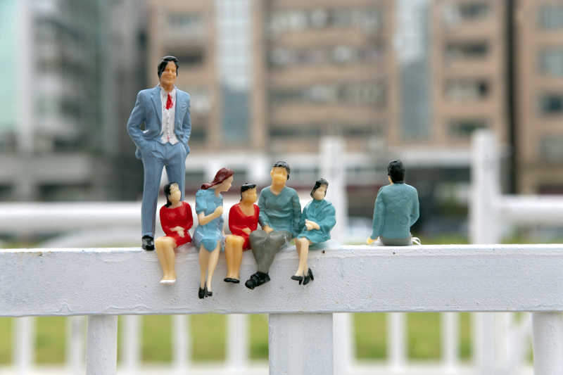 小型玩偶坐在栏杆上