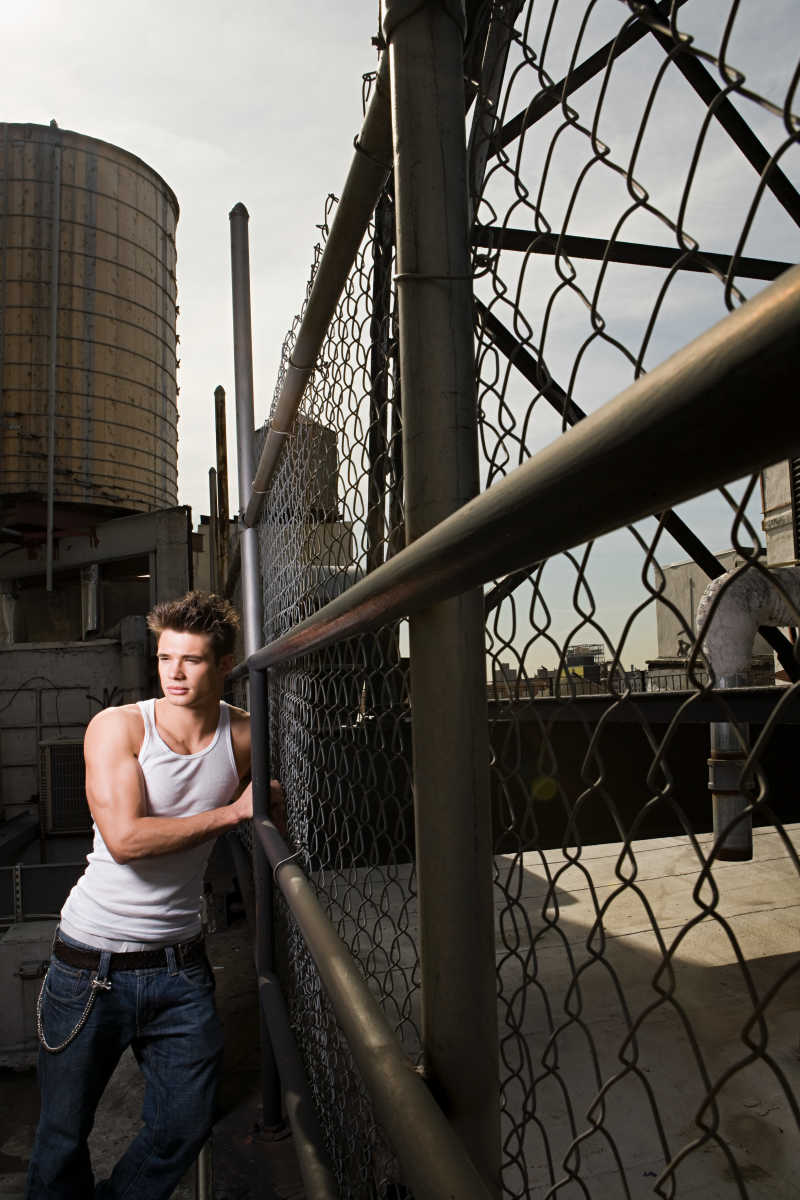 倚在篱笆上的年轻人