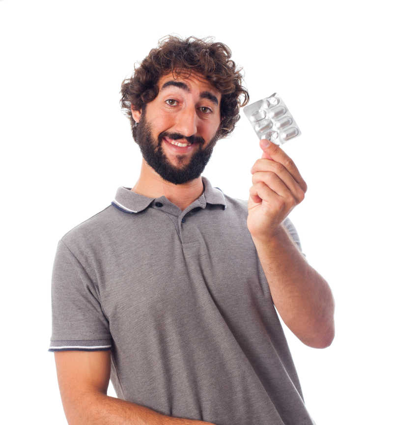 拿着药丸的成年男子