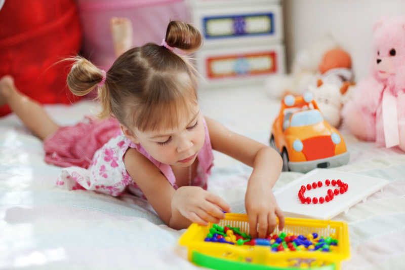 小女孩在她的卧室里玩