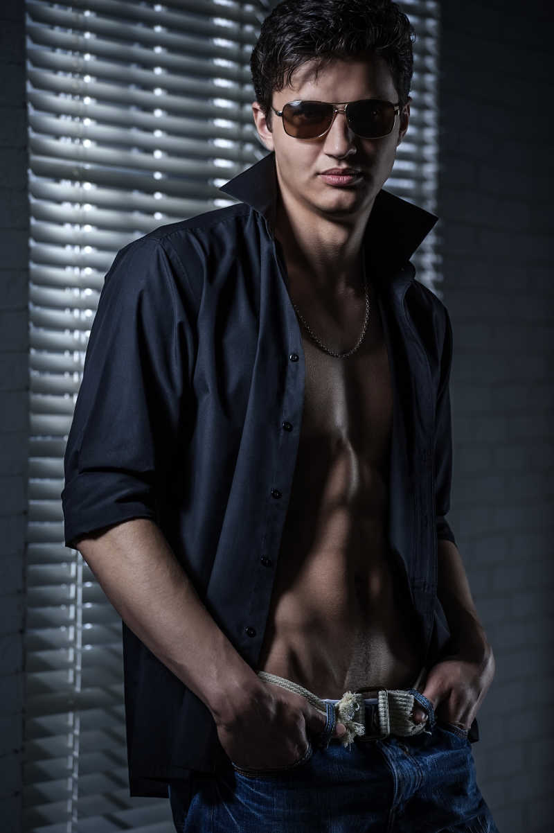 深色背景下年轻英俊男子