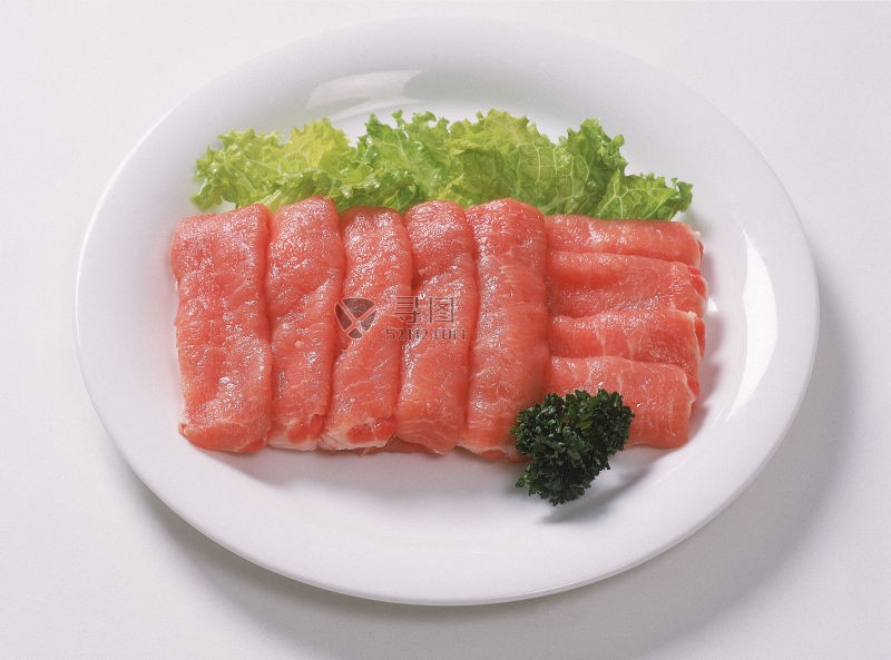 盘子里的猪肉块和生菜