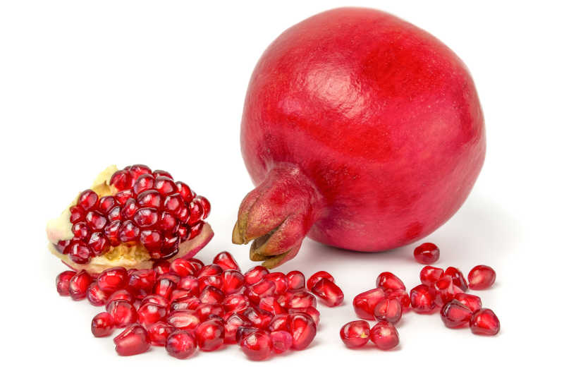 白色背景下的红色石榴和果实