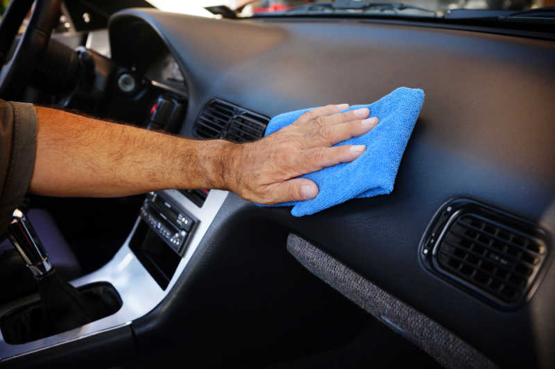 一个男人用超细纤维布清洁车