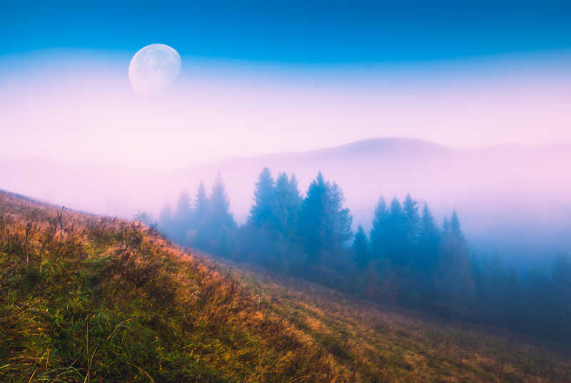 月亮升起在朦胧的山谷之上
