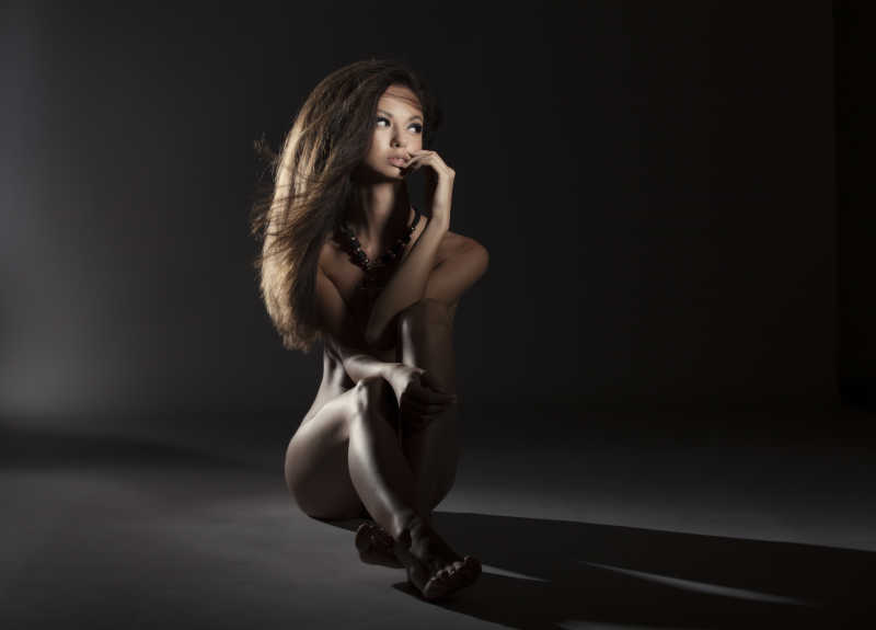 黑色背景下的裸体性感女孩