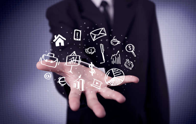 年轻商人的手掌中浮现出白色的商务图标