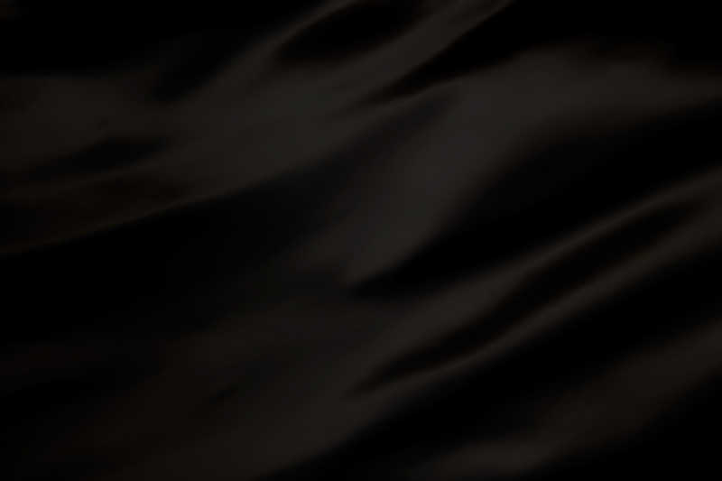 黑色背景下豪华布或蹩脚的丝质缎绒材料的波浪褶皱