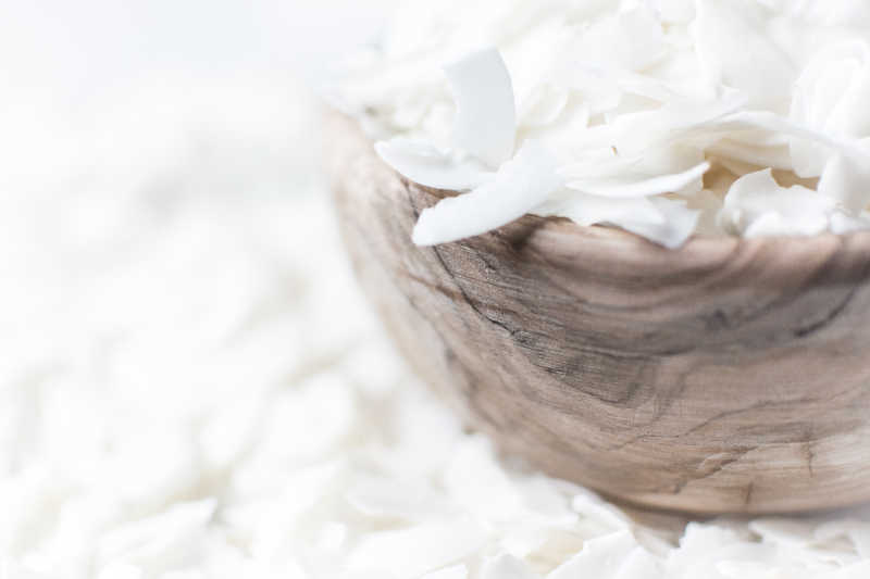 散落的椰蓉上的木碗装椰蓉