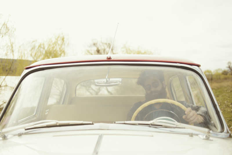 大胡子男人开着老爷车