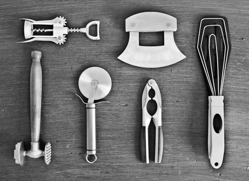 木制餐桌上的金属炊具和配件