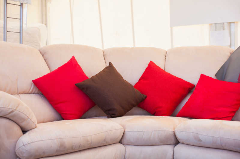 白色沙发上的红色和棕色沙发枕