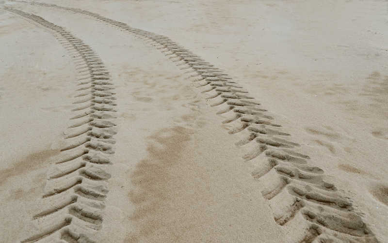 海滩上留下的车辆开过的痕迹