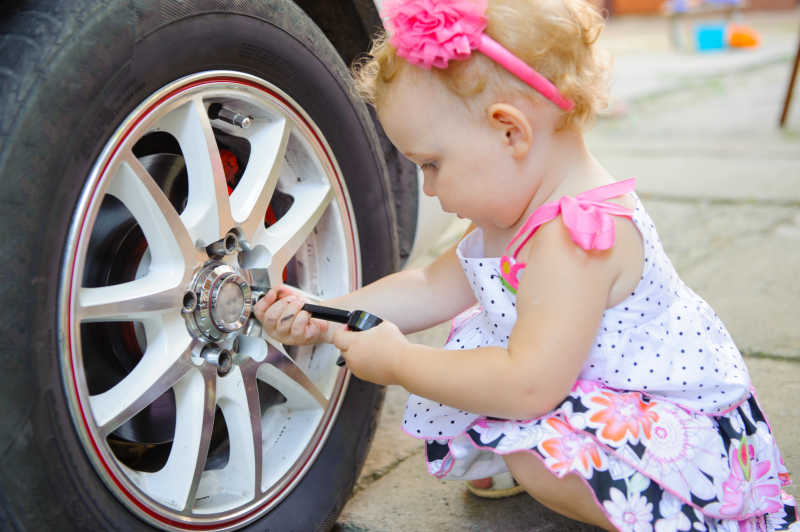 小女孩正在修理汽车轮胎