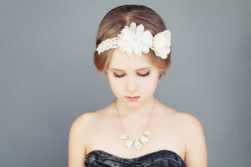 可爱的女孩发型戴着发卡和时尚的着装