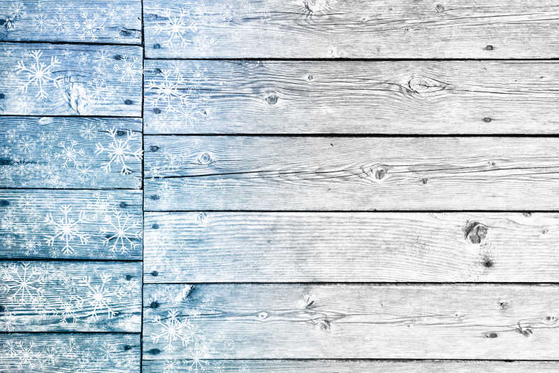 木质板上有雪花插图的纹理背景