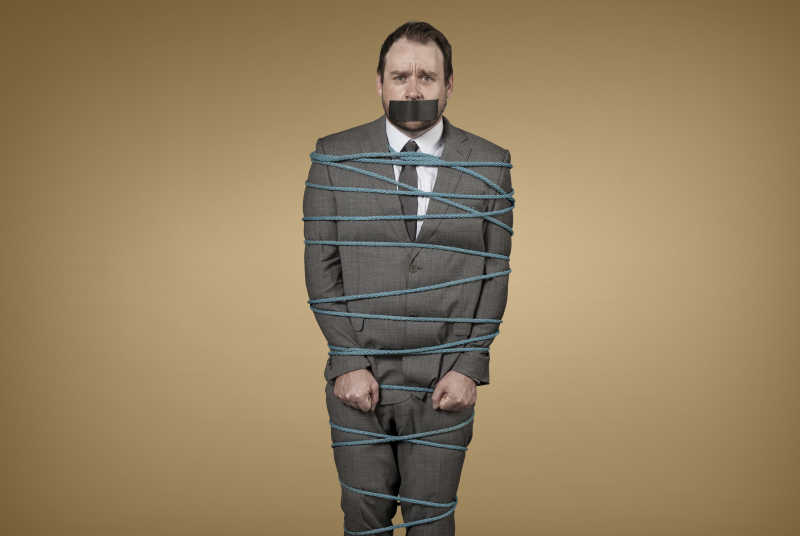 黄色背景上被束缚的男商人