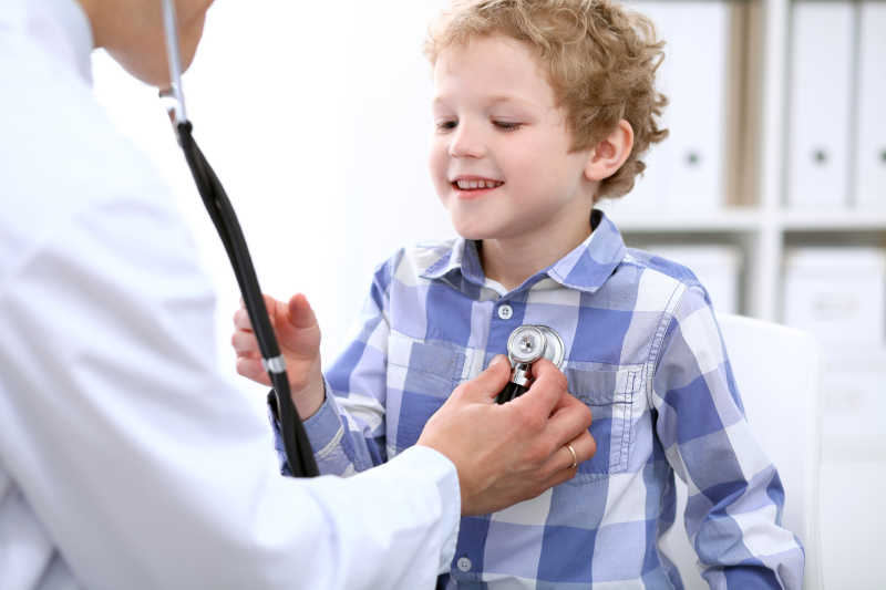 男医生用听筒为孩子做身体检查