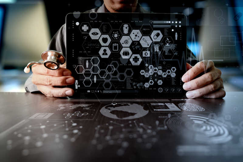 黑色桌上医学博士手工操作现代计算机