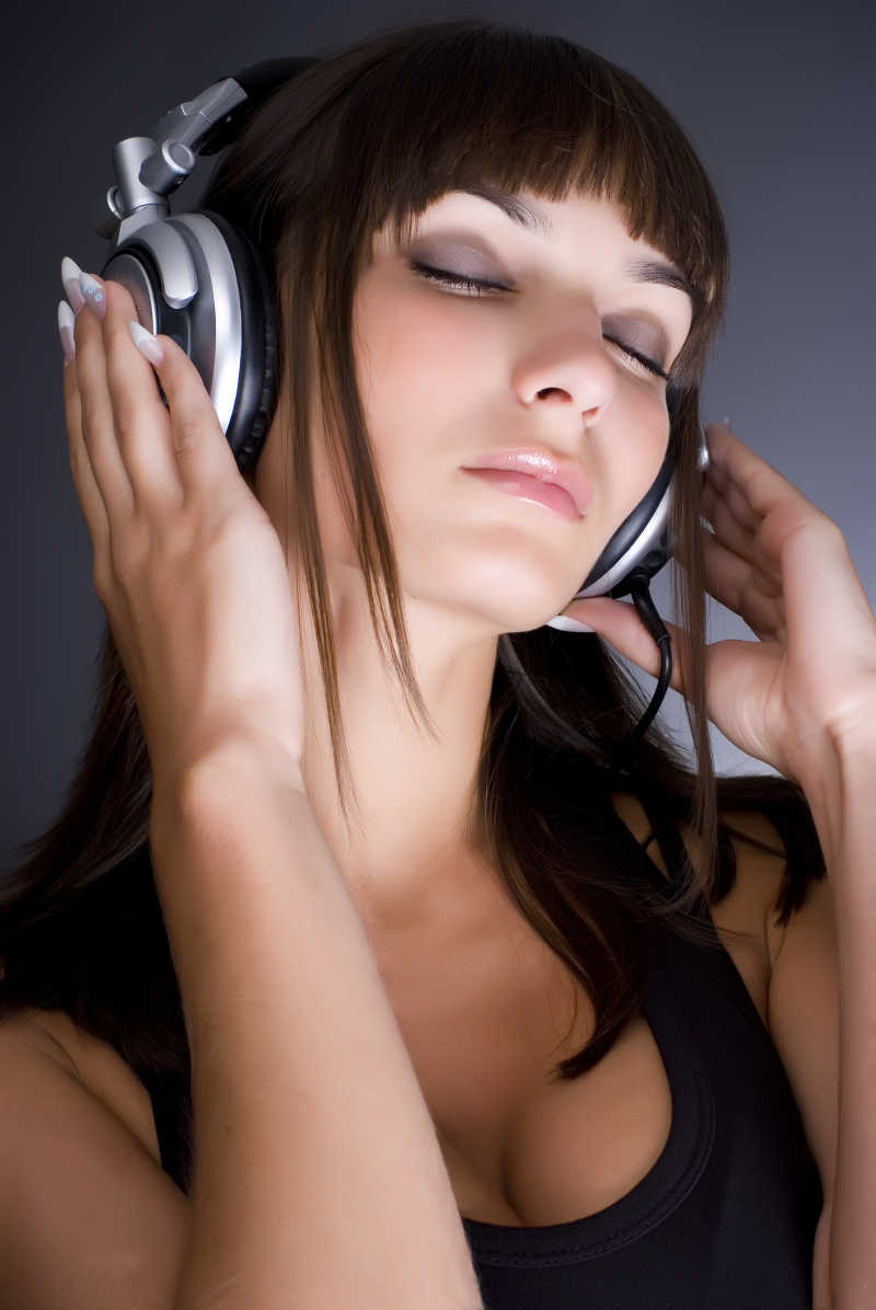 女孩带着耳机听音乐