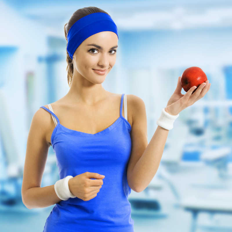 微笑着拿着苹果的女人