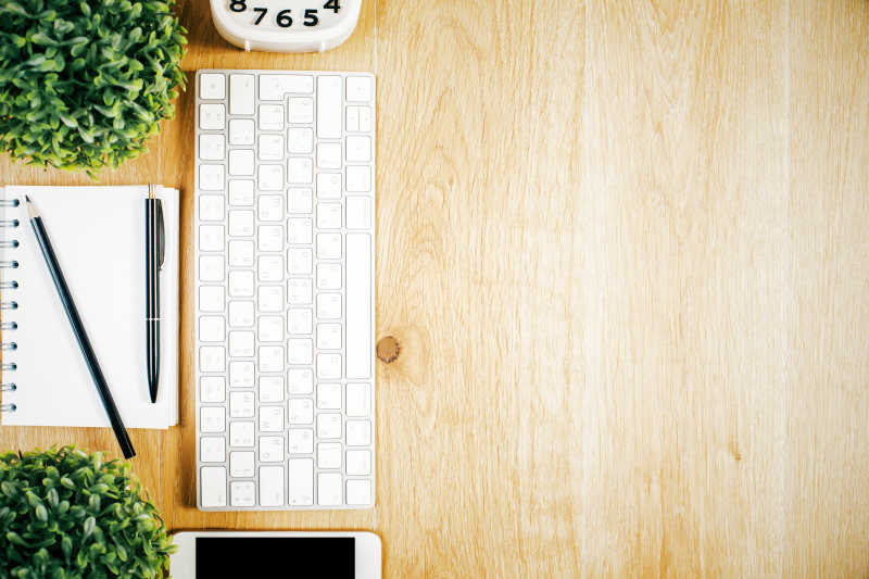 木桌上的键盘手机