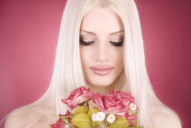 拿着粉色花束的美丽女人