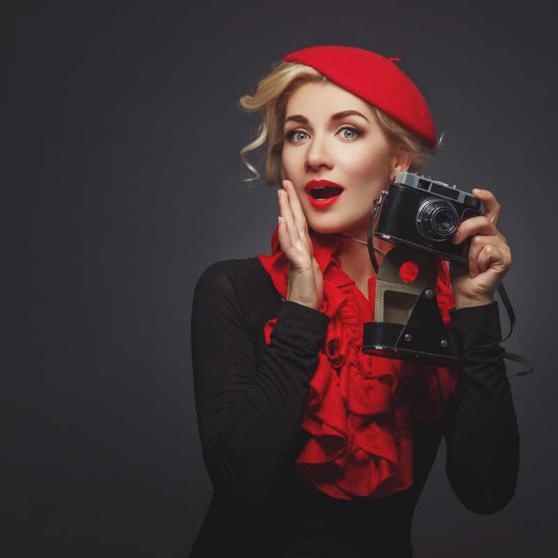 戴着红色贝雷帽的美女拿着相机