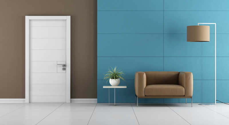 当代家庭入口白色门和皮革扶手椅以及蓝色墙壁