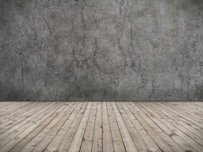 有水泥墙和木地板的房间